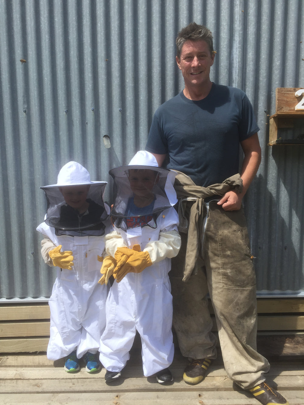 Children in a beekeeping suits